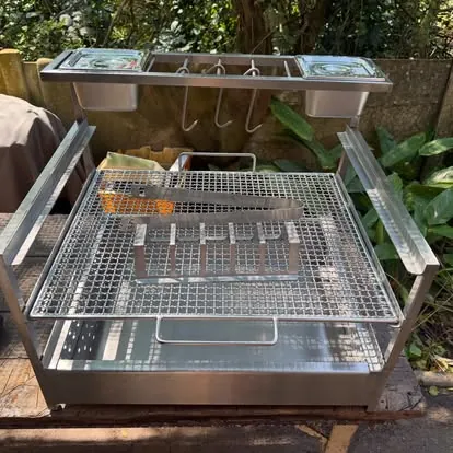 Custom wood-fired grill with warmer trays and grill basket