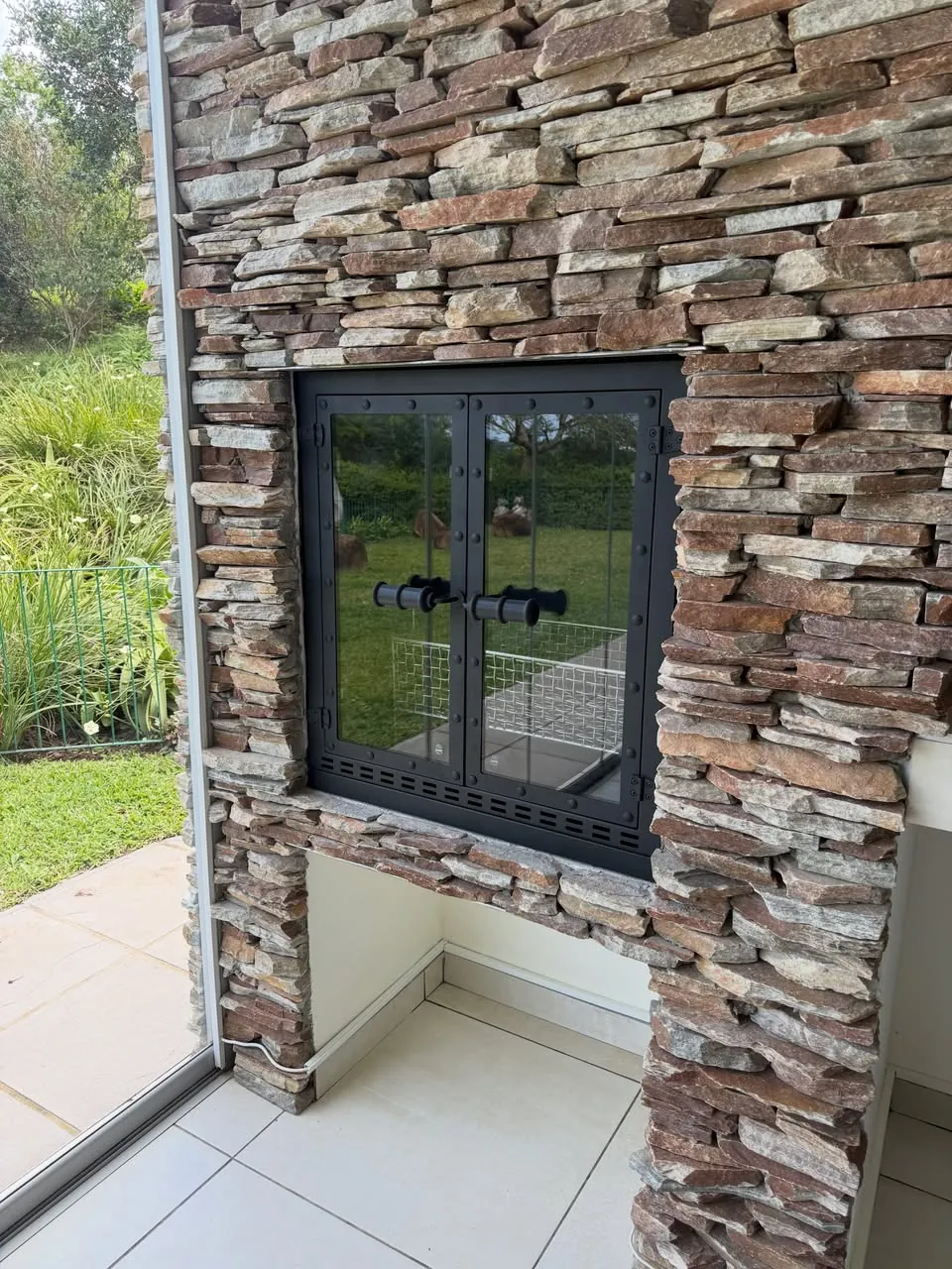 Fire-proof door in a stone braai wall