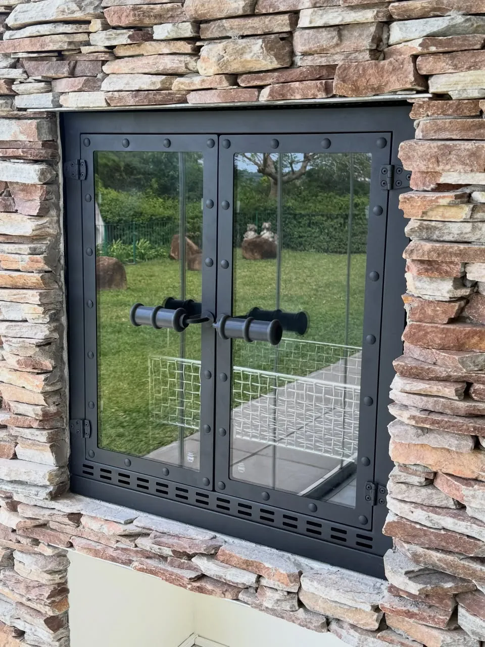 Fire-proof door: Double doors with riveted frame and glass.