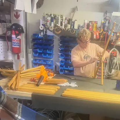 Morne assembling camp chair frames in the MS Creations workshop